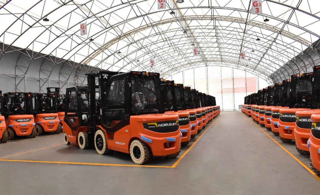 Rows of Noblelift forklifts lined up in the warehouse